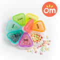Colorful 7-day portable travel pill organizer with daily weekday compartments
